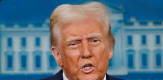 Man speaking at press conference podium