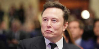 Man in suit at an event looking sideways