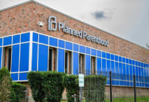 Brick building with blue windows and logo signage