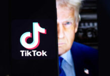 TikTok logo on screen with mans face behind