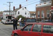 Police officer directing traffic near ambulance scene