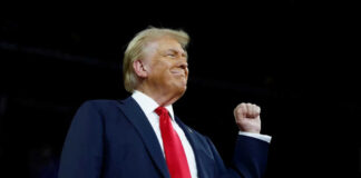 Man in suit with raised fist in air