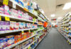 Pharmacy aisle stocked with various medicine and products