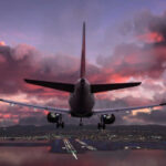 Airplane approaching airport runway at sunset sky