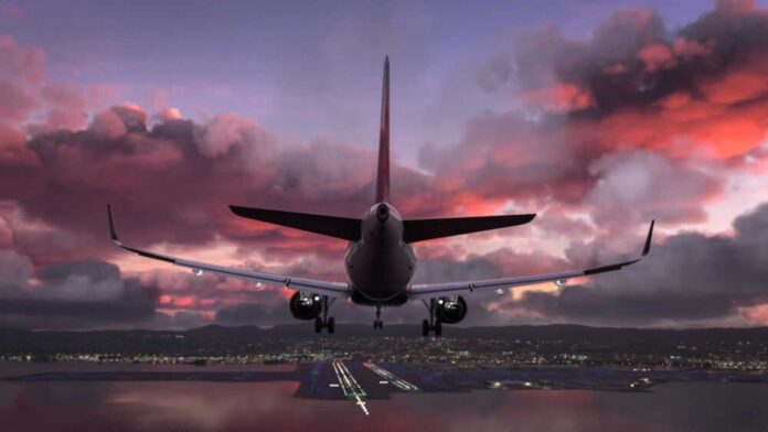 Airplane approaching airport runway at sunset sky