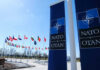 NATO flags and banners under clear blue sky